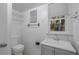 Bathroom featuring a white sink, toilet, and window with natural light at 1214 Flomich St, Daytona Beach, FL 32117