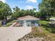 Charming home featuring a cozy front yard, fresh gravel, new paint, and an inviting front entrance at 1214 Flomich St, Daytona Beach, FL 32117