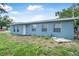 Exterior facade of a blue home with multiple windows and a modest front yard at 1214 Flomich St, Daytona Beach, FL 32117