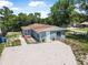 Charming home with a gravel driveway and lush greenery, creating a welcoming and serene ambiance at 1214 Flomich St, Daytona Beach, FL 32117