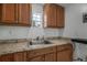Kitchen with stainless steel sink, countertop, and wooden cabinetry at 1214 Flomich St, Daytona Beach, FL 32117