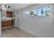 This kitchen area offers tile flooring and a large window, brightening the space at 1214 Flomich St, Daytona Beach, FL 32117