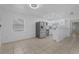 Modern kitchen with stainless steel appliances, white cabinetry, and tiled floor, perfect for culinary enthusiasts at 1214 Flomich St, Daytona Beach, FL 32117