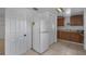 This kitchen features tile flooring, white appliances, and white cabinets at 1214 Flomich St, Daytona Beach, FL 32117