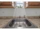 Close-up on a stainless steel sink and faucet with a view out the window at 1214 Flomich St, Daytona Beach, FL 32117