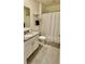 Neutral bathroom featuring granite counters, tiled floors, and white cabinetry at 1216 August Sky Dr, Deltona, FL 32738
