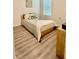 Charming bedroom with a full-size bed, wood-look flooring, and soft lighting, making it a relaxing space at 1216 August Sky Dr, Deltona, FL 32738