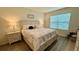 Cozy bedroom featuring a queen-size bed, wood-look flooring, and soft lighting, offering a peaceful retreat at 1216 August Sky Dr, Deltona, FL 32738