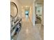 Bright entryway with ceramic tile flooring, high ceilings, and an ornate console table, perfect for a welcoming ambiance at 1216 August Sky Dr, Deltona, FL 32738