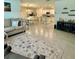 Open-concept living room with ceramic tile flooring and views into the dining and kitchen areas, great for entertaining at 1216 August Sky Dr, Deltona, FL 32738