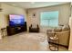 Comfortable living room with ceramic tile flooring, a large window, and neutral tones, creating a relaxing atmosphere at 1216 August Sky Dr, Deltona, FL 32738