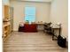 Functional home office space with wood-look flooring, a large window, and a desk area, great for productivity at 1216 August Sky Dr, Deltona, FL 32738