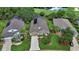 Aerial view of a well-maintained home with landscaped yard, screened-in porch, and golf course views at 1329 Sunningdale Ln, Ormond Beach, FL 32174