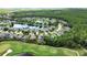 Scenic aerial view of a residential area with a golf course, pond, and beautiful landscaping at 1329 Sunningdale Ln, Ormond Beach, FL 32174