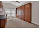 Bedroom featuring custom built-in wood storage cabinets with plenty of shelving, drawers, and decorative chair rail at 1329 Sunningdale Ln, Ormond Beach, FL 32174