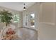 Bright foyer with tile flooring, a decorative plant, and a view through double doors to the outside at 1329 Sunningdale Ln, Ormond Beach, FL 32174