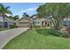 Inviting single-story home with lush green lawn, mature landscaping, and well-maintained exterior at 1329 Sunningdale Ln, Ormond Beach, FL 32174