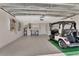 Garage with epoxy flooring and golf cart at 1329 Sunningdale Ln, Ormond Beach, FL 32174