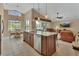 Spacious kitchen featuring a large island with seating, modern appliances, and an open view of the living area at 1329 Sunningdale Ln, Ormond Beach, FL 32174