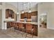 Modern kitchen boasts dark wood cabinetry, stainless steel appliances, and a large island with bar seating at 1329 Sunningdale Ln, Ormond Beach, FL 32174