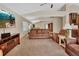 Open living area featuring neutral carpeting, modern media console, and comfortable seating arrangements at 1329 Sunningdale Ln, Ormond Beach, FL 32174