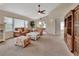 Open living area with high ceilings, neutral carpet, and french doors providing backyard access at 1329 Sunningdale Ln, Ormond Beach, FL 32174