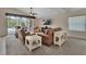 Bright living room features a ceiling fan, plush seating, TV, and a sliding glass door to the outdoor area at 1329 Sunningdale Ln, Ormond Beach, FL 32174