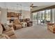 Inviting living room with a view of the outdoor pool area, kitchen access, and comfortable seating at 1329 Sunningdale Ln, Ormond Beach, FL 32174