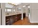 Elegant bathroom with dual sinks, granite countertops, dark wood cabinets, and a glass-enclosed shower at 1329 Sunningdale Ln, Ormond Beach, FL 32174