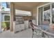 Screened-in patio with BBQ and granite countertops at 1329 Sunningdale Ln, Ormond Beach, FL 32174