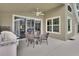 Covered patio with BBQ, dining set, and ceiling fan at 1329 Sunningdale Ln, Ormond Beach, FL 32174