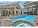 Backyard pool and spa area with covered patio and screened enclosure provide space for entertaining at 1329 Sunningdale Ln, Ormond Beach, FL 32174