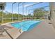 Screened-in pool with spa and lush landscaping at 1329 Sunningdale Ln, Ormond Beach, FL 32174