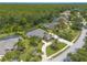 A high angle view shows mature trees surrounding the property that also features a screened pool at 15 Cambridge Trce, Ormond Beach, FL 32174