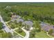 Aerial view of a home on a tree lined street near preserved wetlands and green spaces at 15 Cambridge Trce, Ormond Beach, FL 32174