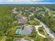 A beautiful aerial view shows a well-maintained neighborhood with many trees and green spaces at 15 Cambridge Trce, Ormond Beach, FL 32174