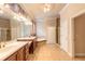 Well-appointed bathroom with tiled flooring, dual sinks, a soaking tub, and a glass shower at 15 Cambridge Trce, Ormond Beach, FL 32174