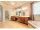 Bathroom showcasing double vanity sinks, a soaking tub, and a separate shower at 15 Cambridge Trce, Ormond Beach, FL 32174