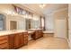 Elegant bathroom with dual vanities, tile flooring, a soaking tub, and a separate shower at 15 Cambridge Trce, Ormond Beach, FL 32174