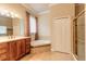 Bathroom featuring tiled flooring, dual sinks, a soaking tub, and a glass shower at 15 Cambridge Trce, Ormond Beach, FL 32174