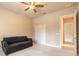 Neutral carpeted bedroom with sofa, ceiling fan and access to other rooms at 15 Cambridge Trce, Ormond Beach, FL 32174