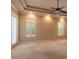 Spacious bedroom with tray ceilings, large windows and bright, neutral carpet at 15 Cambridge Trce, Ormond Beach, FL 32174