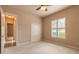 Neutral bedroom featuring plush carpet, ceiling fan, closet and window with natural light at 15 Cambridge Trce, Ormond Beach, FL 32174