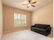 Carpeted bedroom featuring a ceiling fan, sofa and bright window with natural light at 15 Cambridge Trce, Ormond Beach, FL 32174