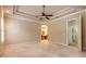 Spacious bedroom featuring tray ceilings, neutral carpeting, and an ensuite bathroom at 15 Cambridge Trce, Ormond Beach, FL 32174