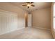 Bright bedroom featuring neutral paint, plush carpet, double closet and a ceiling fan at 15 Cambridge Trce, Ormond Beach, FL 32174