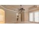 Bright bedroom with light carpeting, a ceiling fan, and sliding glass doors to the outdoors at 15 Cambridge Trce, Ormond Beach, FL 32174