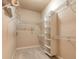 Walk-in closet with white wire shelving and carpet flooring providing ample storage space at 15 Cambridge Trce, Ormond Beach, FL 32174