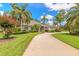 Charming home with a circular driveway and lush green lawn surrounded by trees at 15 Cambridge Trce, Ormond Beach, FL 32174