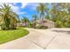 Beautiful home with lush green lawn, circular driveway and three-car garage at 15 Cambridge Trce, Ormond Beach, FL 32174